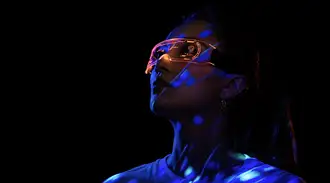 Woman wearing futuristic AR glasses with illuminated display
