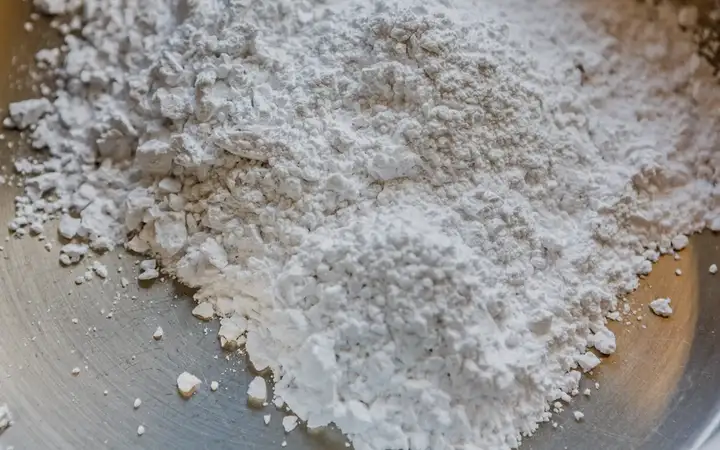 White powder in a metal dish.