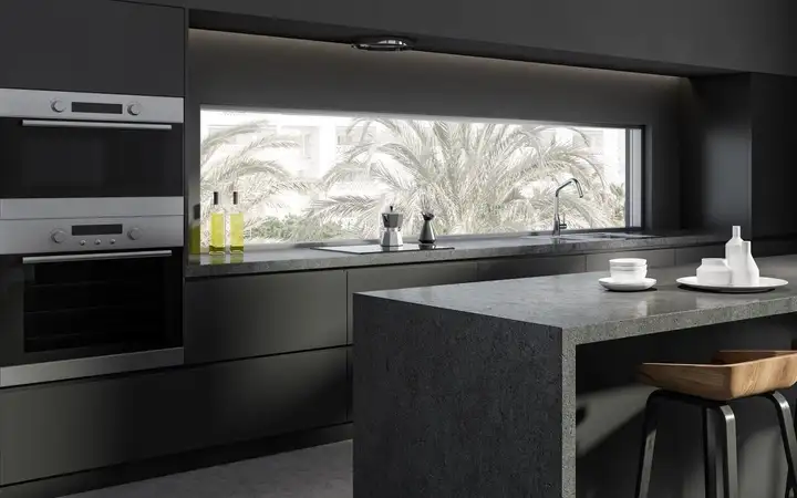 Sleek dark modern domestic kitchen with a range of appliances