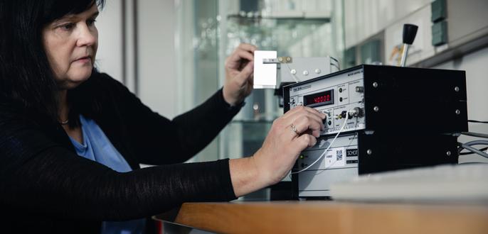 A researcher adjusts a test device.