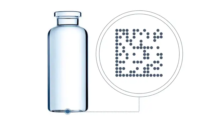 Pharmaceutical glass vial with a laser code on the bottom plus microscopic view of the code