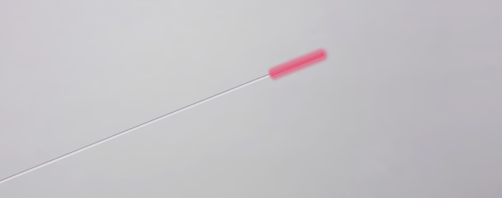 rendering of a cylindrical laser diffusor with a delivery fiber with white sheathing, radiating red light, set against a gray background.