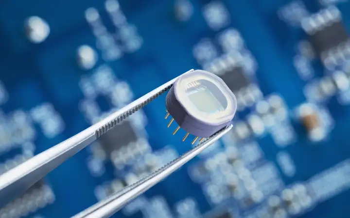Tweezers holding electronic microchip