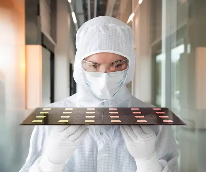 Scientist inspecting glass-based semiconductor packaging