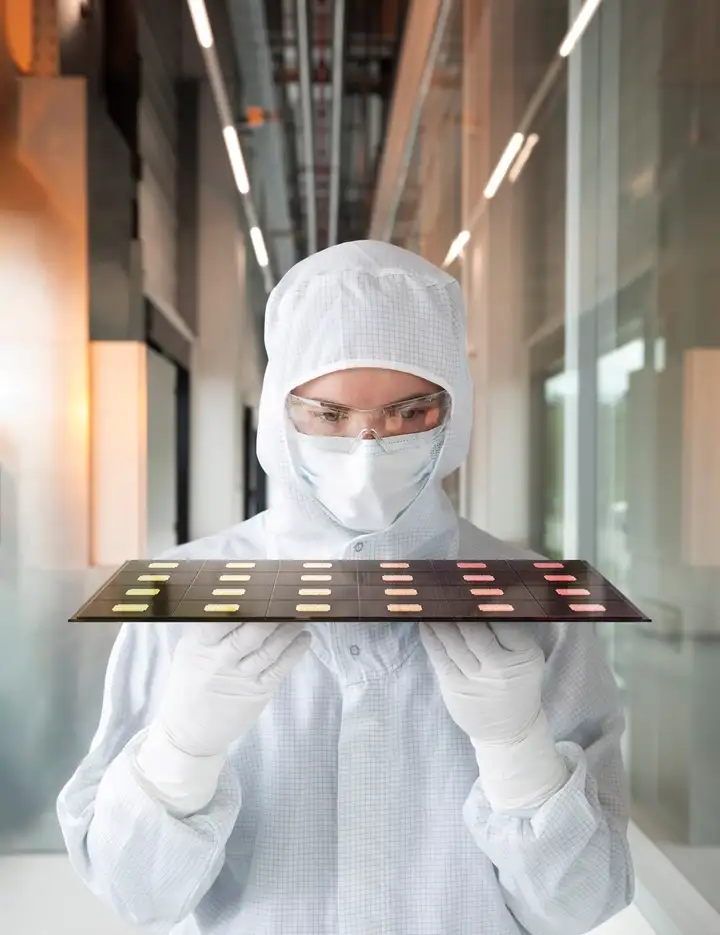 Scientist inspecting glass-based semiconductor packaging