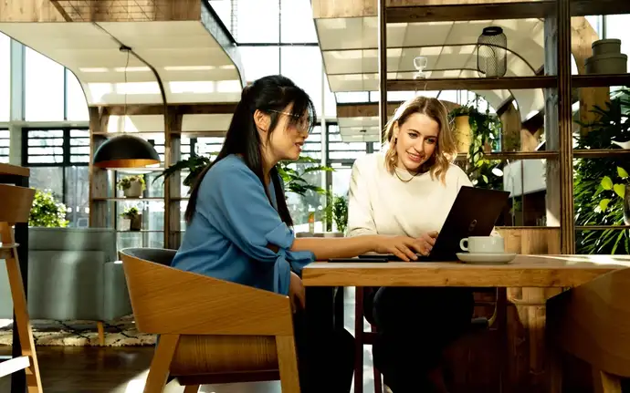 Two women looking at a laptop screen