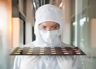 Scientist inspecting glass-based semiconductor packaging