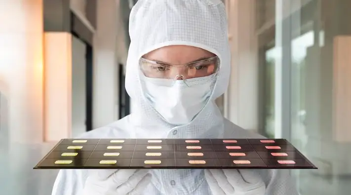 Scientist inspecting glass-based semiconductor packaging