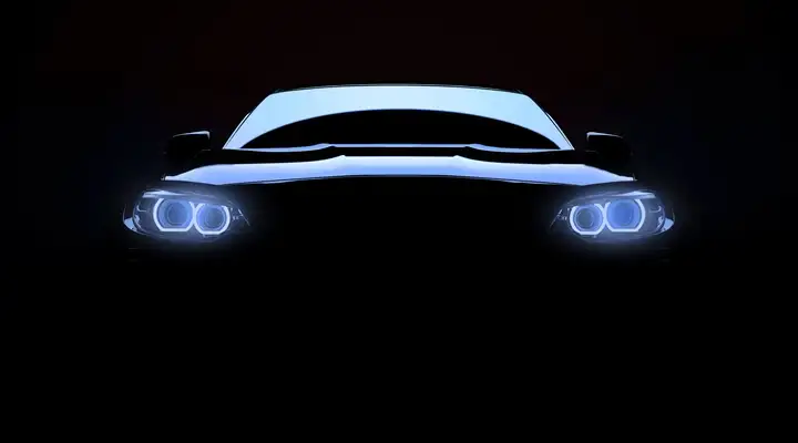 Front view of a luxury vehicle with headlights on