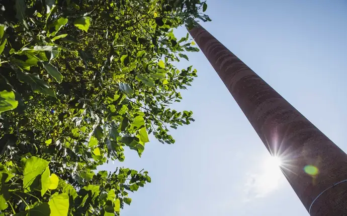 Close-up of the chimney of the SCHOTT plant in Mainz in the landscape