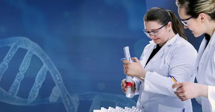 Two woman dressed with lab coat holding testing equipment