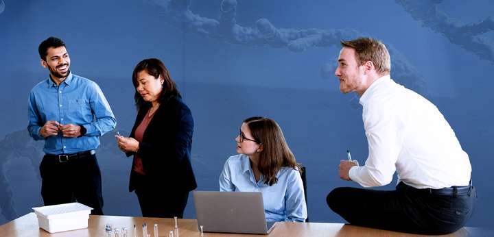Group of young people in business clothing talking in a meeting room
