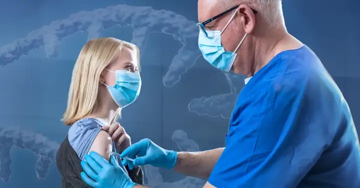 Woman getting an injection from a doctor via syringe.