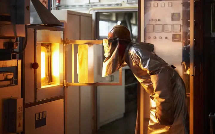 Worker in production checking the Furnace