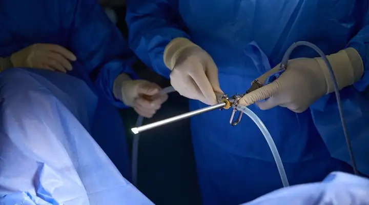 Surgeon using an endoscope with precision optical instruments during a medical procedure
