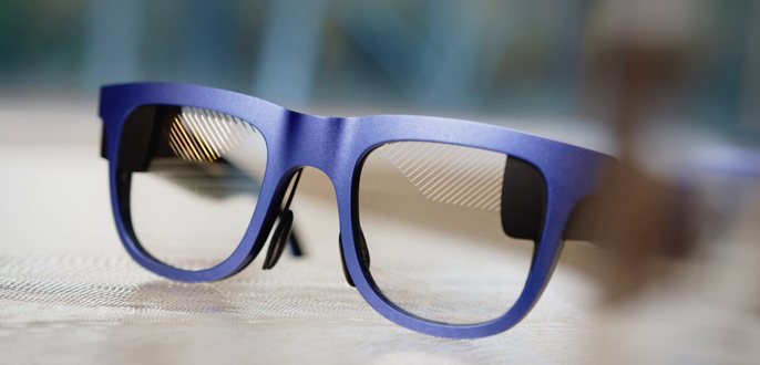  A blue pair of glasses with subtly diagonal lines reflecting in the upper corner 