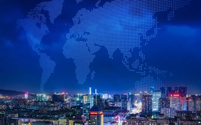 City skyline in front of a map of the world